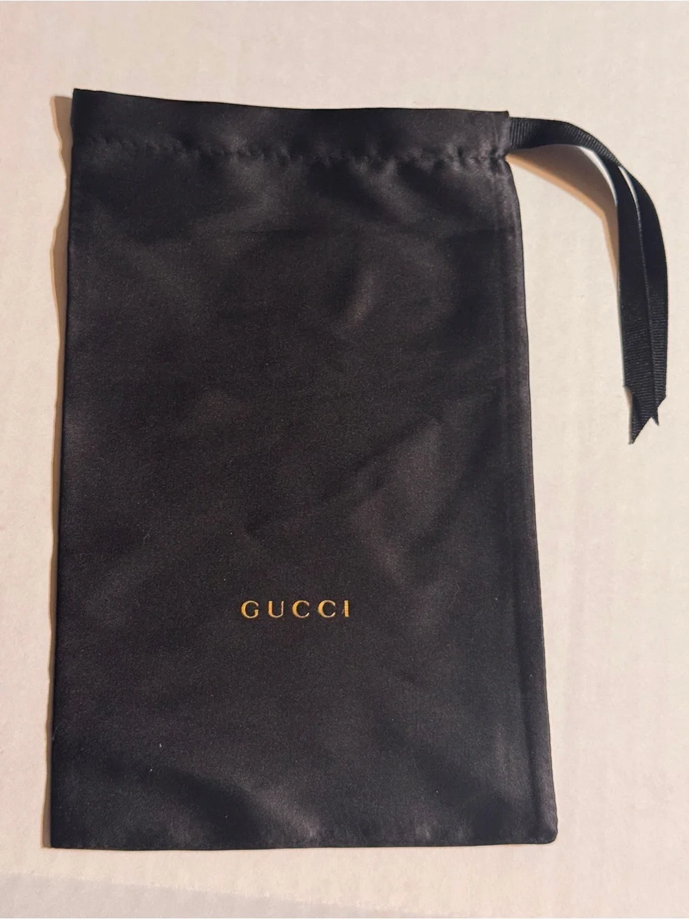 A Gucci Eyewear Case in Black and Dark Gray with Gold Logo